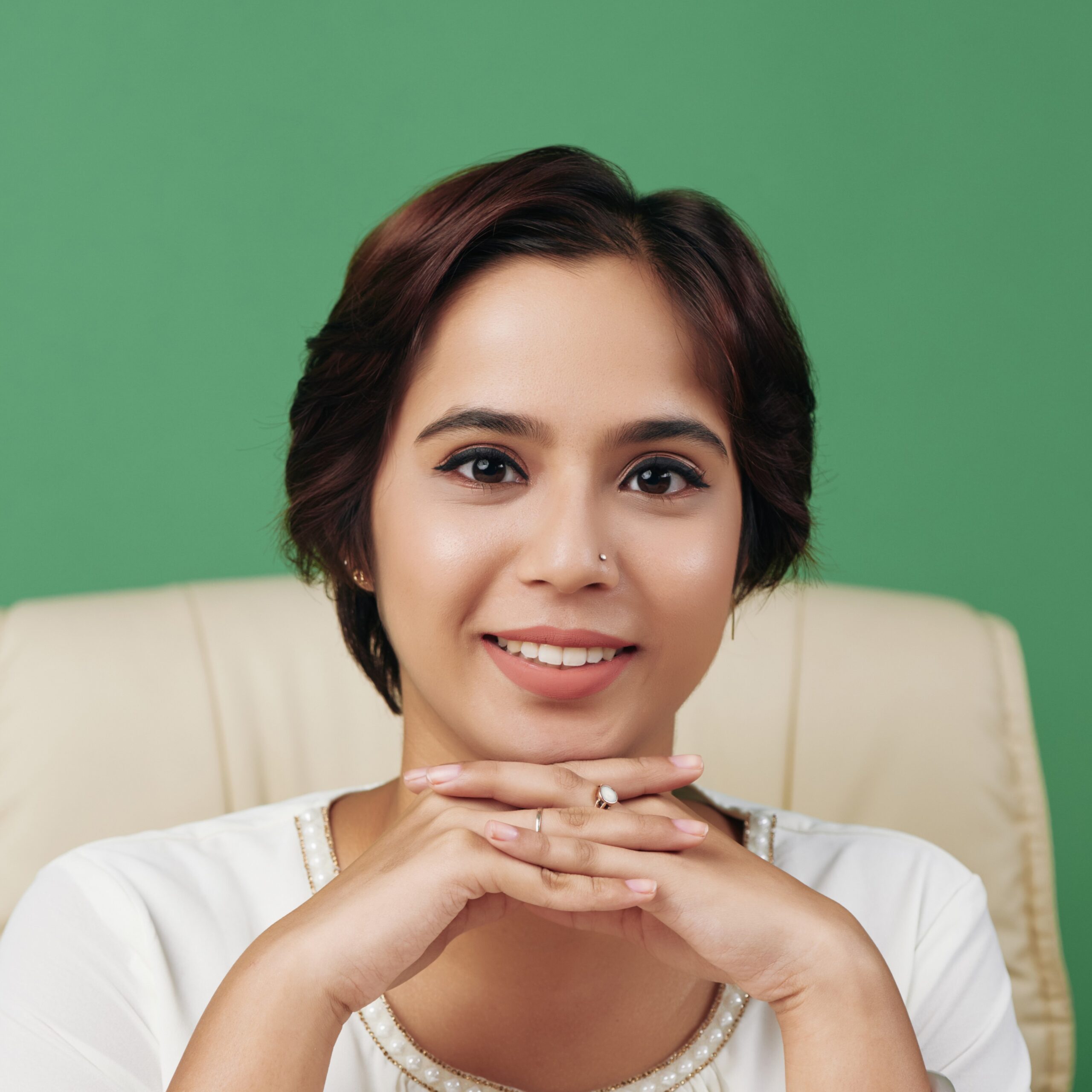 Portrait of confident young business woman sitting at her table and looking at camera